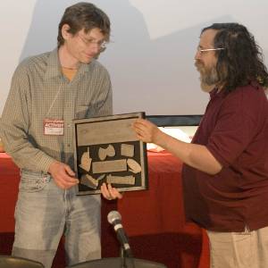 Richard Stallman presenting the Free Software Foundation Award for Projects of Social Benefit to Mike Linksvayer, Vice President of Creative Commons.