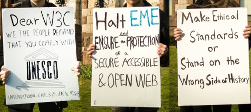 Three protest signs against DRM.