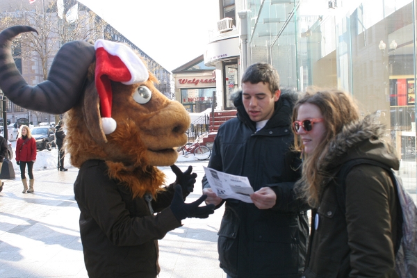 An activist sharing the Giving Guide at a Giveaway.