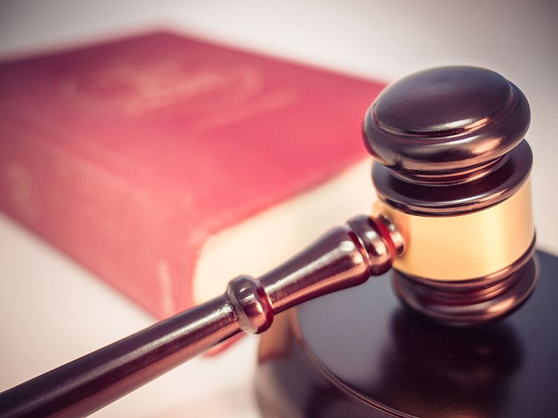 A judge's gavel over a law book.