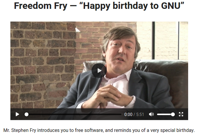 Frame from the video with Stephen Fry sitting in a chair
