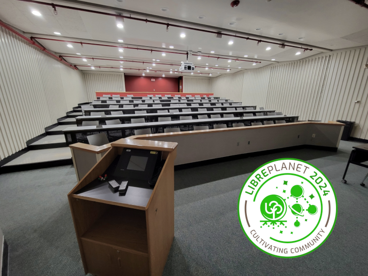 A classroom at the Wentworth Institute of Technology with the LibrePlanet 2024 logo on it.